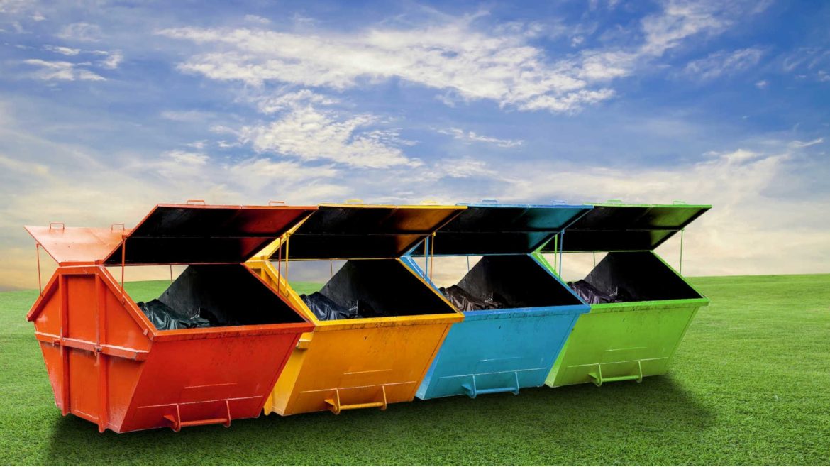 A row of skip bins in different colours according to their waste type.